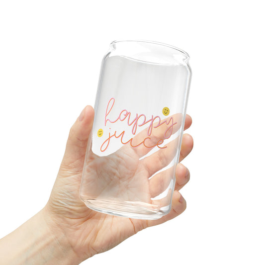 Clear glass tumbler with 'Happy Juice' text held by a hand on a white background