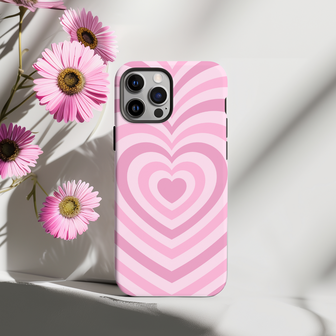 Phone case with pink heart pattern on a light background with flowers