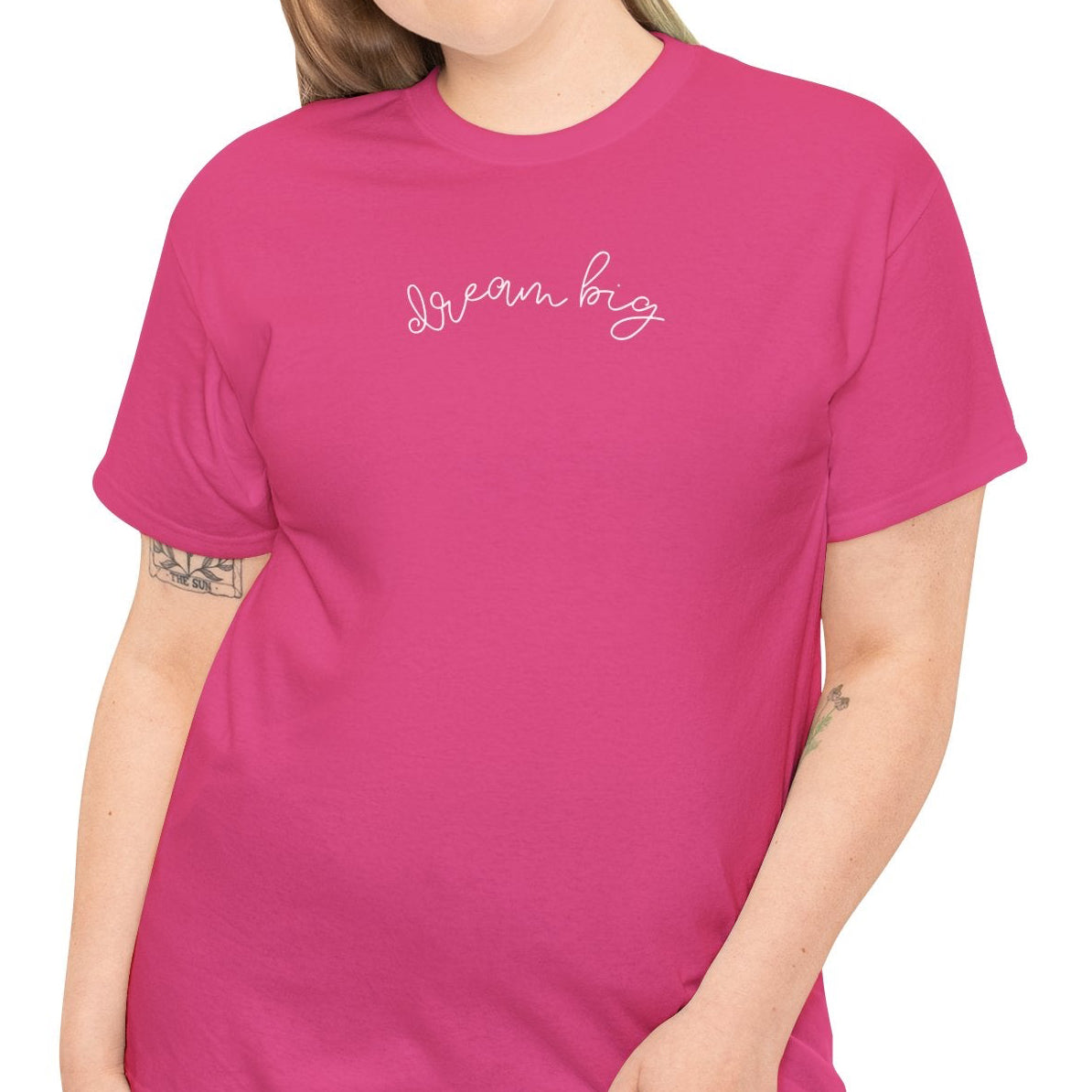 Woman wearing a pink t-shirt with text on a white background