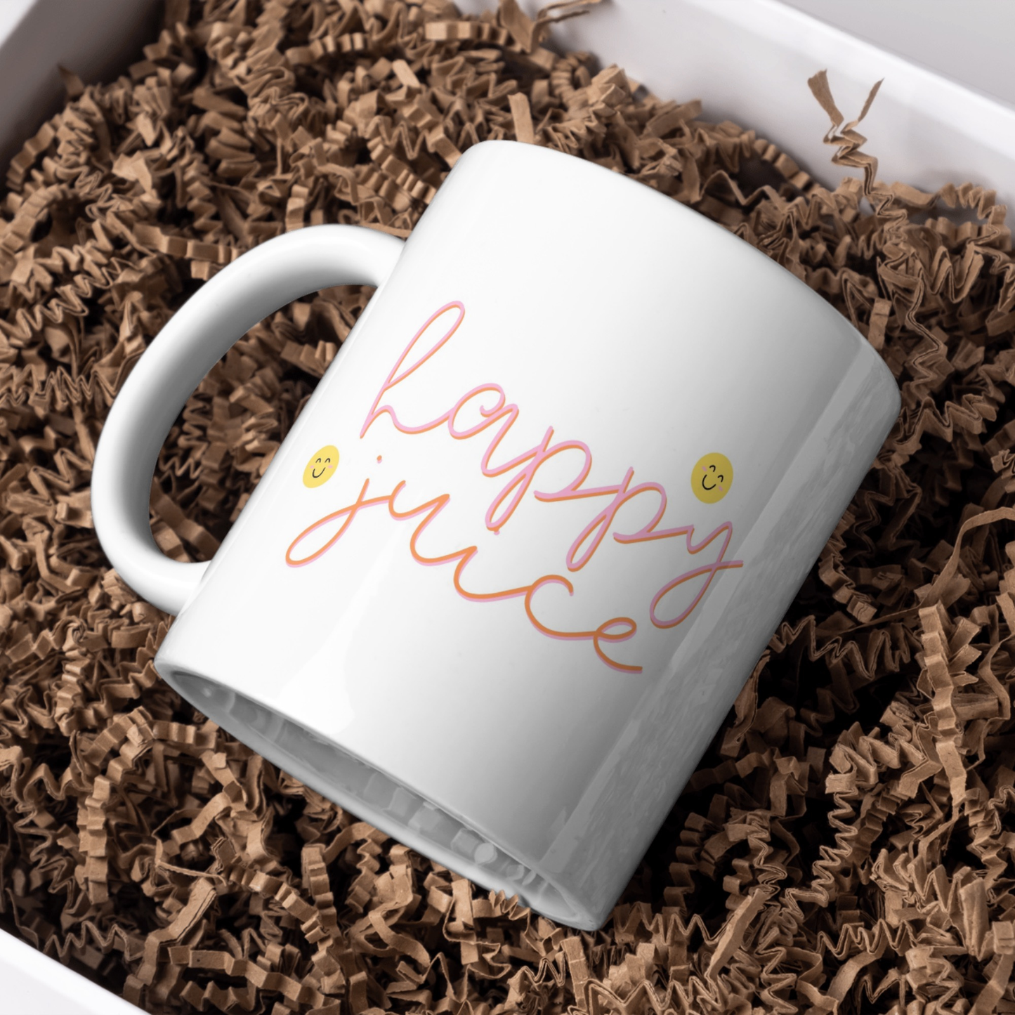 White mug with 'Happy Juice' text on brown crinkled paper