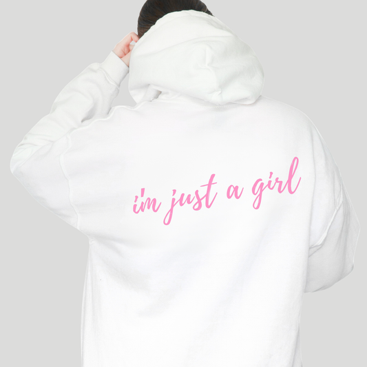 White hoodie with 'i'm just a girl' text on the back against a gray background