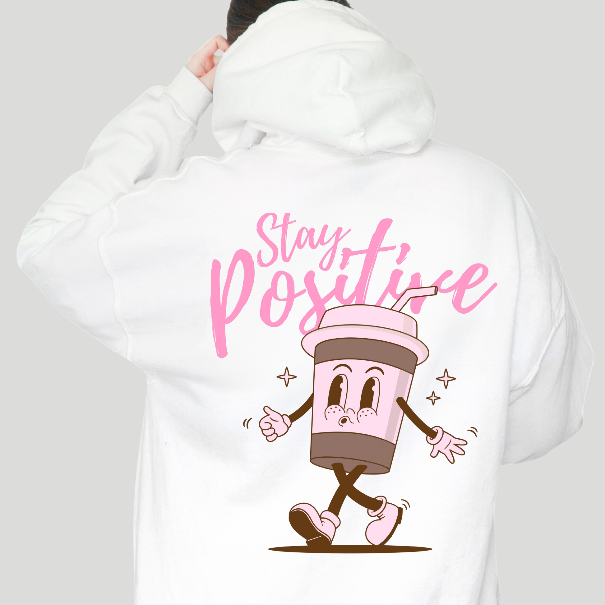 White hoodie with 'Stay Positive' text and cartoon cup design on the back.
