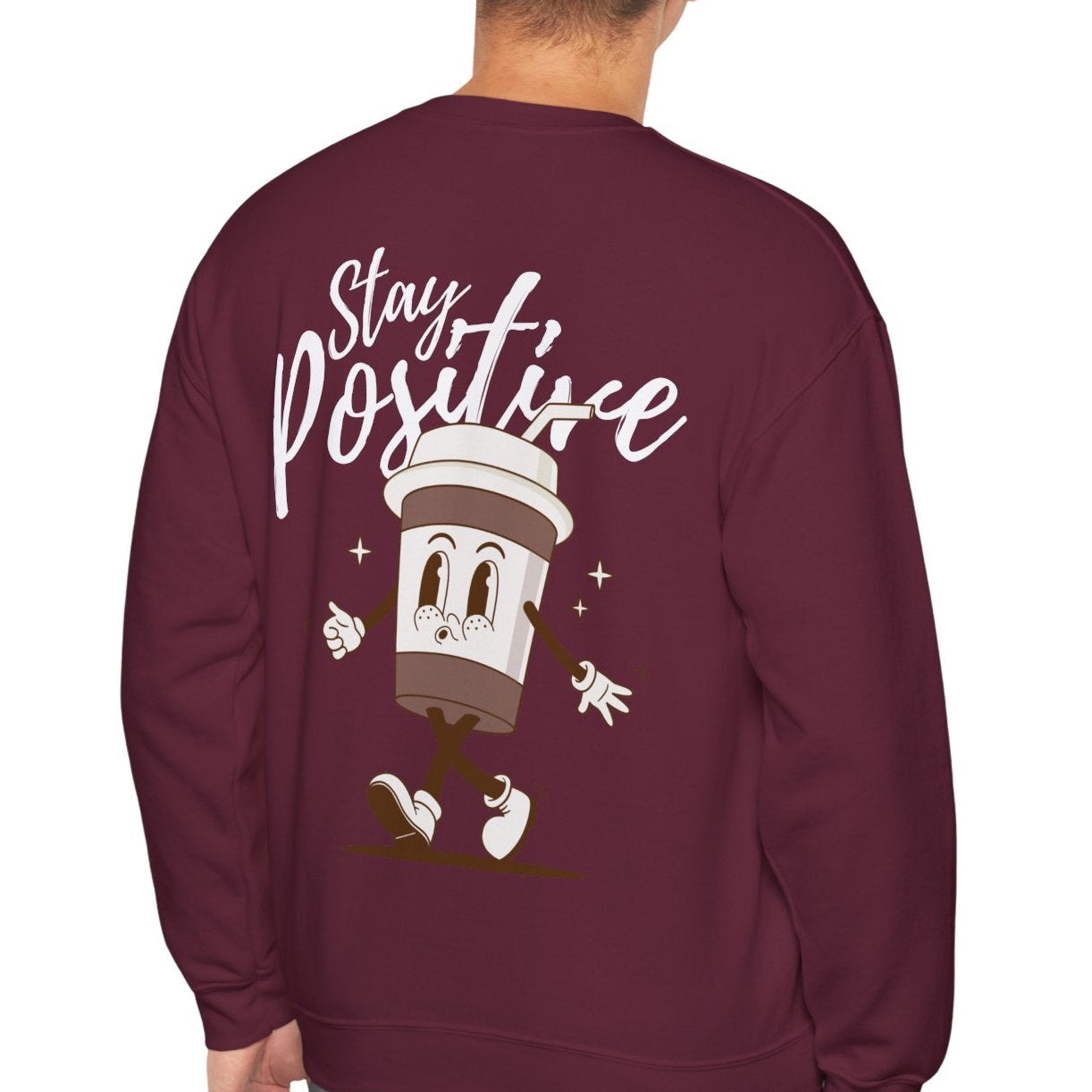 Maroon sweatshirt with 'Stay Positive' text and cartoon design on the back, worn by a person.