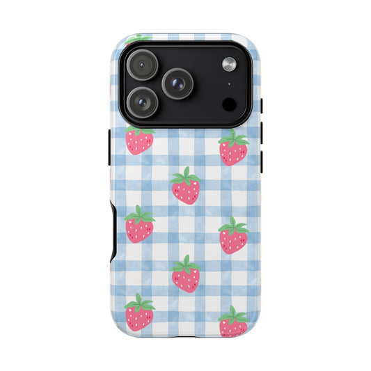 Phone case with blue checkered pattern and pink strawberries on a white background