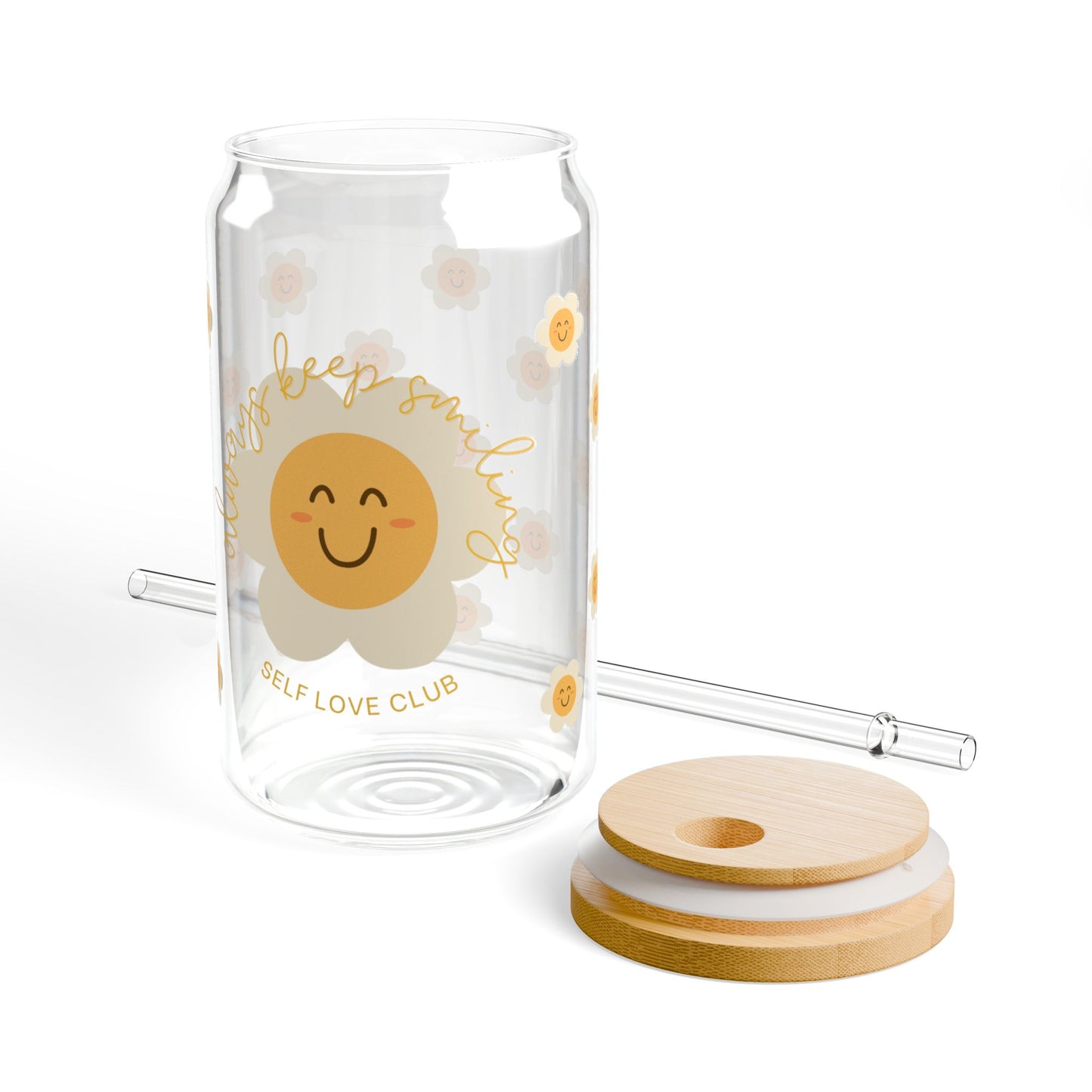 Clear glass tumbler with happy flower design, straw, and wooden lid on a white background