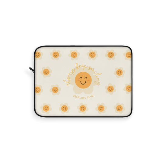 Laptop sleeve with happy flower face pattern and text on a white background
