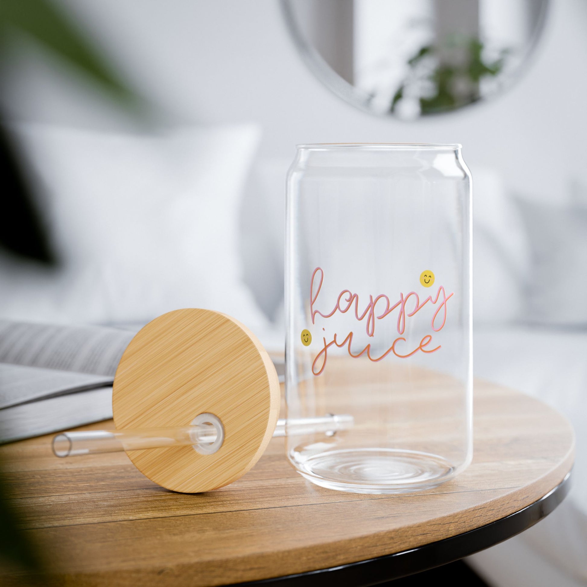 Clear glass with 'happy juice' text on a wooden table
